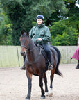 EQUIDRY men's waterproof short blouson style horse riding jacket in black forest green shown on horse