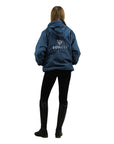 EQUIDRY women's waterproof short blouson style horse riding jacket in steel blue back view studio shot