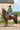 EQUIDRY women's long waterproof horse riding coat in black forest green/cream modelled by rider out hacking on horse showing storm skirts 