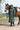 EQUIDRY women's long waterproof horse riding coat in black forest green/green shown by rider stood with horse
