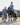 EQUIDRY women's long waterproof horse riding coat in steel blue/charcoal group family shot with horse and dog in matching rug and coat