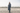 EQUIDRY Charcoal Equimac long waterproof lightweight riding coat modelled by female horse riding instructor 