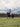 EQUIDRY women's long waterproof horse riding coat in blue lilac/grey rider hacking with horse