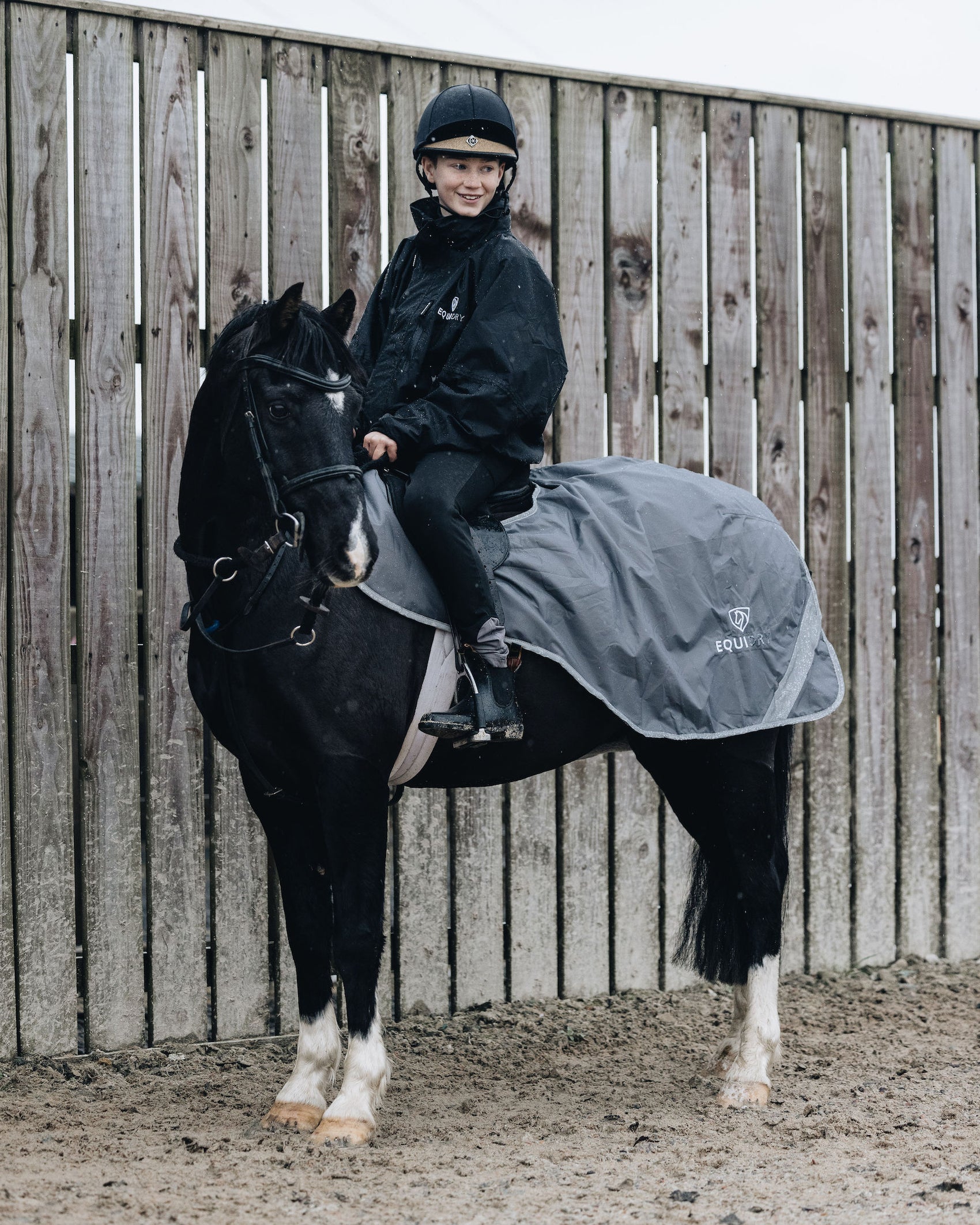 Shortie Child's Oversized Short Waterproof blouson style Riding Jacket Thin Fleece Lining Stowaway Hood in black rider on horse